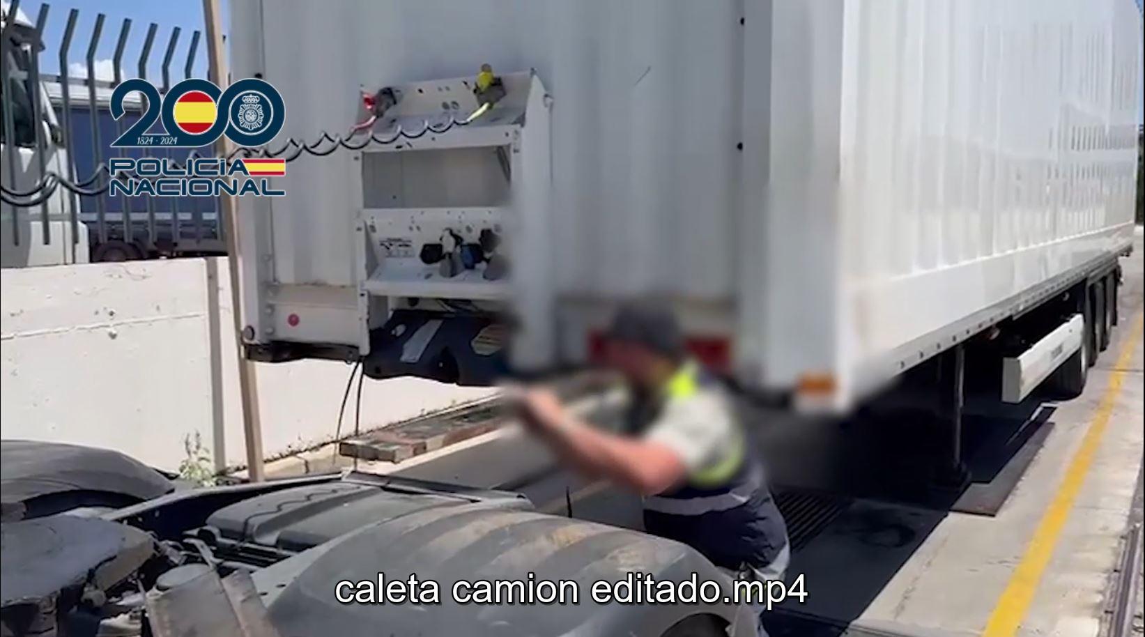 Un agente saca la caleta oculta con droga que se ocultaba en el remolque del camión